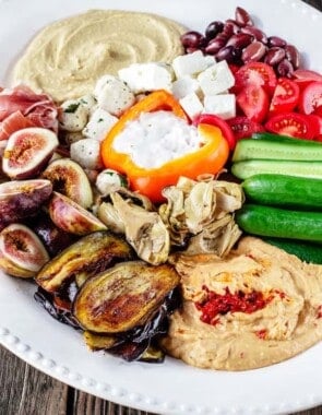 Mezze: How to Build the Perfect Mediterranean Party Platter | The Mediterranean Dish . Ditch boring party platters and try this no-cook, impressive Mediterranean mezze platter. With Sabra hummus, yogurt dip, veggies, olives, cheeses, and more! Pin it for your next party!