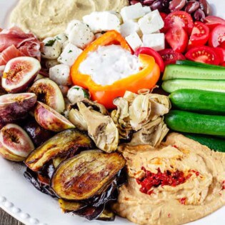 Mezze: How to Build the Perfect Mediterranean Party Platter | The Mediterranean Dish . Ditch boring party platters and try this no-cook, impressive Mediterranean mezze platter. With Sabra hummus, yogurt dip, veggies, olives, cheeses, and more! Pin it for your next party!