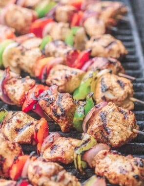 Chicken kabobs arranged on an open-flamed grill