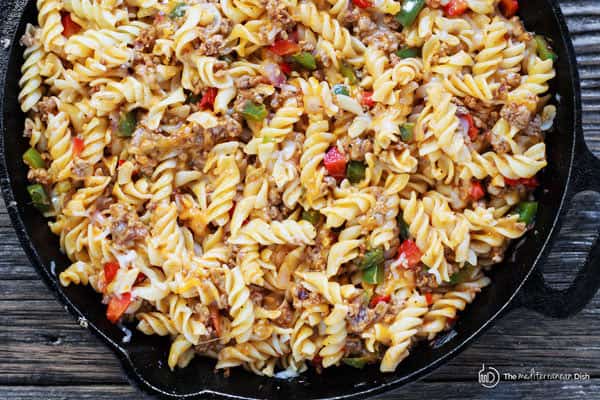 One-Skillet Macaroni and Cheese with Italian Sausage and Bell Peppers | The Mediterranean Dish. Try this delicious Italian twist on macaroni and cheese! The perfect comfort skillet meal; comes together in minutes! 