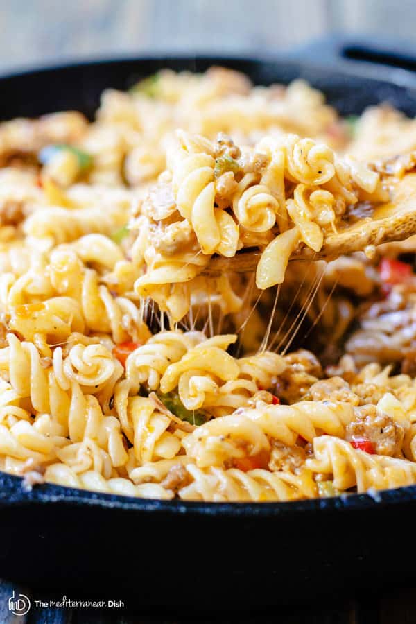 One-Skillet Macaroni and Cheese with Italian Sausage and Bell Peppers | The Mediterranean Dish. Try this delicious Italian twist on macaroni and cheese! The perfect comfort skillet meal; comes together in minutes! 