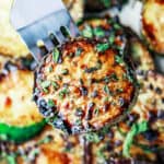 Easy Skillet Zucchini Recipe with Balsamic Reduction | The Mediterranean Dish. This is simply the best side dish! Zucchini rounds sauteed in olive oil and finished with a sweet balsamic reduction, black sesame seeds and a sprinkle of mint flakes. Perfection in minutes!