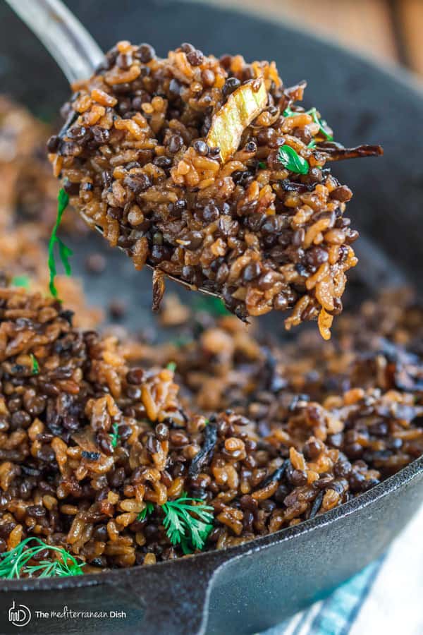 Mujadara Recipe | The Mediterranean Dish. This simple lentils and rice recipe garnished with crispy onions is a signature Middle Eastern Dish that makes for a healthy flavor-packed feast. Vegan, Gluten Free. Check out the easy step-by-step photo instructions at The Mediterranean Dish