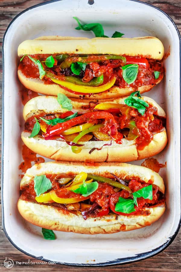 Easy Italian Sausage and Peppers Hoagies | The Mediterranean Dish. These classic Italian-American sandwiches are packed with flavor and super easy to prepare! With an added juiciness from the Tuscan-inspiredBertolli® Tomato & Basil Pasta Sauce. Take your game day or party to the next level!