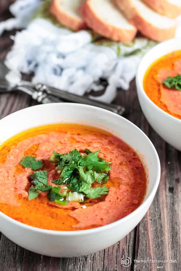 Gazpacho Recipe Easy from Tomato | The Mediterranean dish. Fresh, crunchy and full of flavor! You can do it in 15 minutes! Blend the super ripe tomatoes with other freshly chopped vegetables, garlic and spices. Then cool down add olive oil and a little herbal garnish. And so, dinner is served! Or serve it as an appetizer for parties in small cups or even shooting glasses!