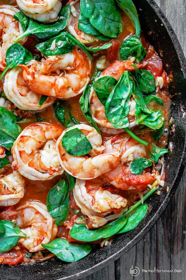 Shrimp with orzo garnished with fresh spinach