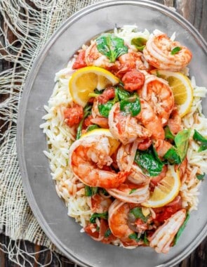 Garlic-Shrimp Orzo Recipe | The Mediterranean Dish. This easy Mediterranean shrimp recipe is the perfect weeknight meal. A few ingredients like white wine, lemon juice, garlic and tomatoes make a special flavor-packed sauce for the prawns or shrimp. Add a simple orzo or pasta of your choice and voila!