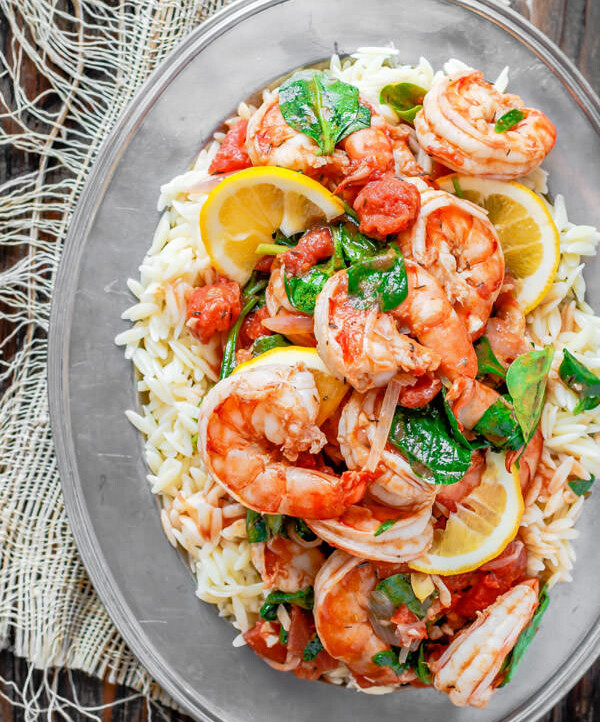 Garlic-Shrimp Orzo Recipe | The Mediterranean Dish. This easy Mediterranean shrimp recipe is the perfect weeknight meal. A few ingredients like white wine, lemon juice, garlic and tomatoes make a special flavor-packed sauce for the prawns or shrimp. Add a simple orzo or pasta of your choice and voila!