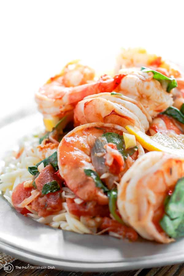 Final product - garlic shrimp with orzo garnished with fresh spinach