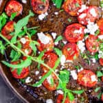 Quick Oven-Roasted Tomato with Thyme and Feta | The Mediterranean Dish. In just 20 minutes you can have the perfect side dish of tomatoes. Tossed in olive oil, lemon juice and thyme. Roasted to perfection and then garnished with feta and your choice of fresh herb. Simple never tasted better!