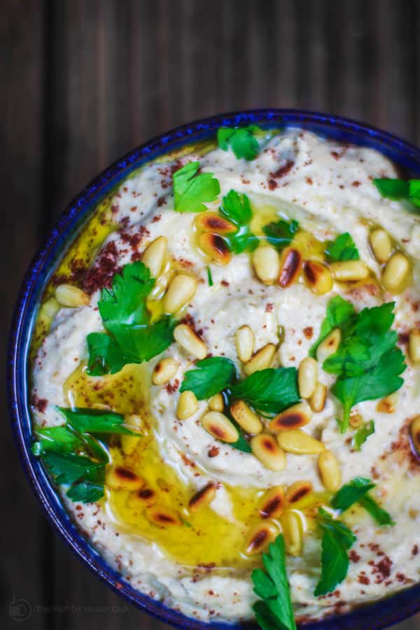 Easy Baba Ganoush Recipe | The Mediterranean Dish. A silky, flavor-packed roasted eggplant dip with tahini, garlic and yogurt. The perfect party appetizer, snack or a spread for your sandwiches. Recipe comes with step-by-step photos!