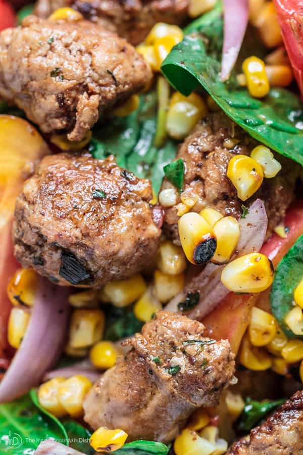 Chorizo is added to the top of the assembled salad