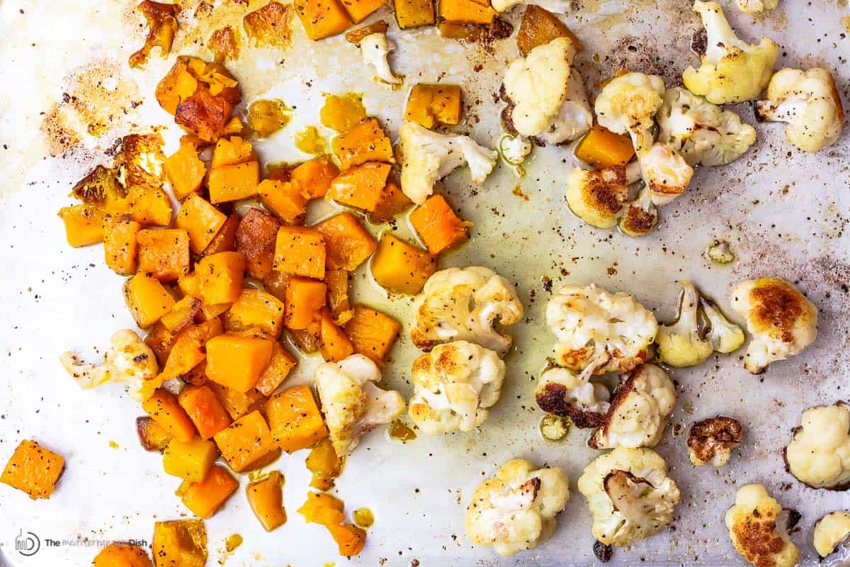 roasted butternut squash and roasted cauliflower on a sheet pan