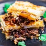 Moussaka Recipe | The Mediterranean Dish. A layered eggplant casserole with potatoes and a hearty spiced meat sauce nestled in between. All topped with a thin cheese-based topping. Step-by-step photos will guide you through cooking this Greek comfort food!