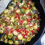 Roasted Brussels Sprouts with Bulgur and Pomegrantes | The Mediterranean Dish. This simple recipe takes brussels sprouts to a new level! Brussels sprouts carmalized to perfection, dressed in a slash of lime juice and tossed with bulgur wheat and pomegranate seeds. The perfect holiday side dish or pick-me-up salad! Try it soon!