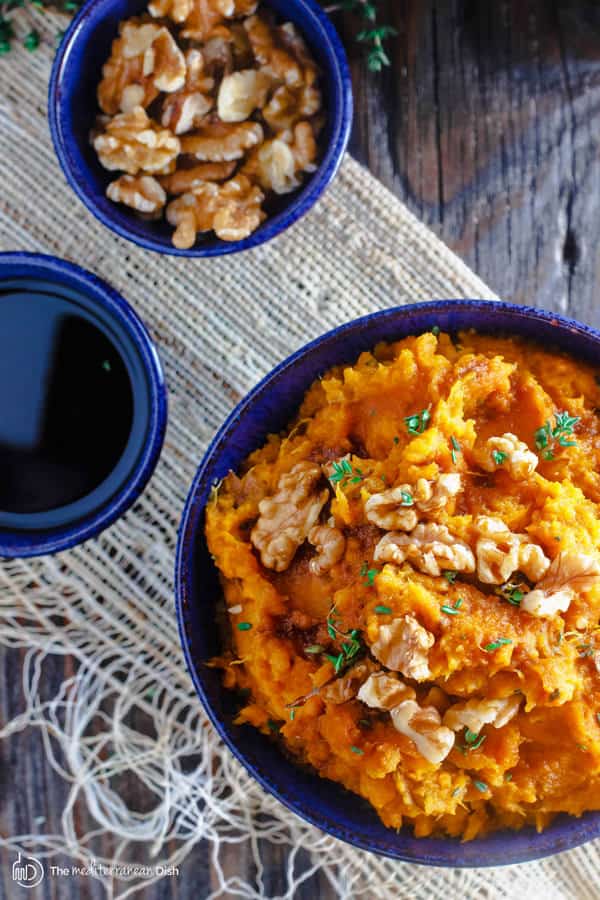 Bowl of Roasted Mashed Sweet Potato with walnuts on the side