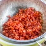 Shrimp Bruschetta Recipe | The Mediterranean Dish. Not your average bruschetta. Fresh tomatoes tossed with shrimp, avocado, green onions, garlic and a good quality basil pesto! A festive and more satisfying appetizer in minutes.