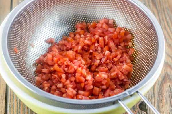 Diced tomatoes in a strainer