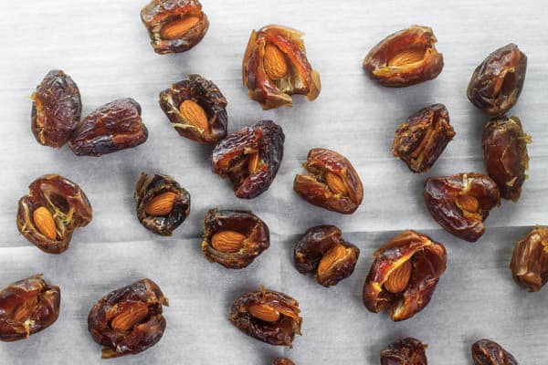 Dates cut open with almond placed inside