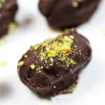 Chocolate Covered Date Recipe | The Mediterranean Dish. Melt-in-your-mouth soft medjool dates, stuffed with almonds and covered in chocolate! An easy make-ahead gluten free (and vegan) dessert. These homemade candy make the perfect edible gift!