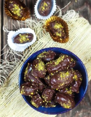 Chocolate Covered Date Recipe | The Mediterranean Dish. Melt-in-your-mouth soft medjool dates, stuffed with almonds and covered in chocolate! An easy make-ahead gluten free (and vegan) dessert. These homemade candy make the perfect edible gift!