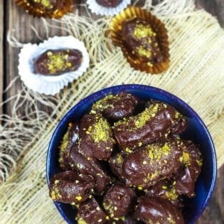 Chocolate Covered Date Recipe | The Mediterranean Dish. Melt-in-your-mouth soft medjool dates, stuffed with almonds and covered in chocolate! An easy make-ahead gluten free (and vegan) dessert. These homemade candy make the perfect edible gift!