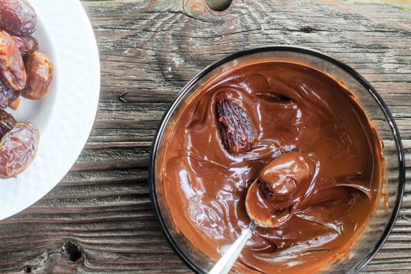 Dates dropped into melted chocolate