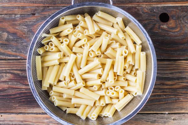 Cooked ziti in a strainer