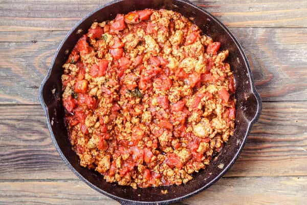 Italian Sausage with canned tomatoes in a skillet