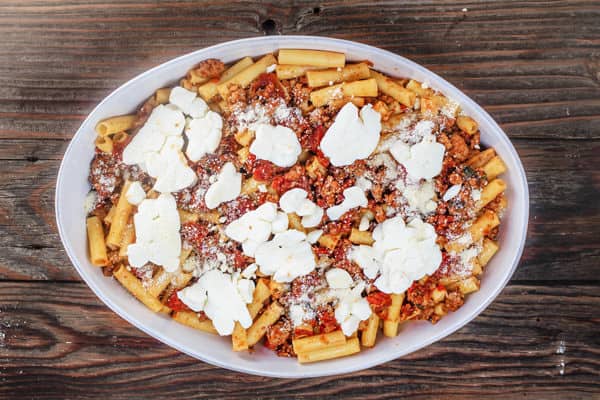 Fresh mozzarella added to the top of ziti, sausage and tomato sauce