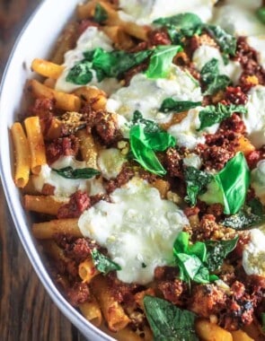 Easy Baked Ziti with Italian Sausage and Fresh Mozzarella | The Mediterranean Dish. This baked ziti relies is a quick and easy one-pan dinner that your family will love! A thick Italian sausage and tomato sauce coats the ziti pasta; add some fresh basil or your favorite Italian herb. I chose fresh mozzarella here, but you can use grated bagged mozzarella instead. Get the recipe today!