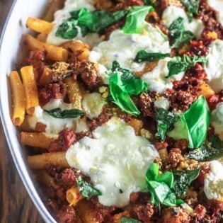Easy Baked Ziti with Italian Sausage and Fresh Mozzarella | The Mediterranean Dish. This baked ziti relies is a quick and easy one-pan dinner that your family will love! A thick Italian sausage and tomato sauce coats the ziti pasta; add some fresh basil or your favorite Italian herb. I chose fresh mozzarella here, but you can use grated bagged mozzarella instead. Get the recipe today!
