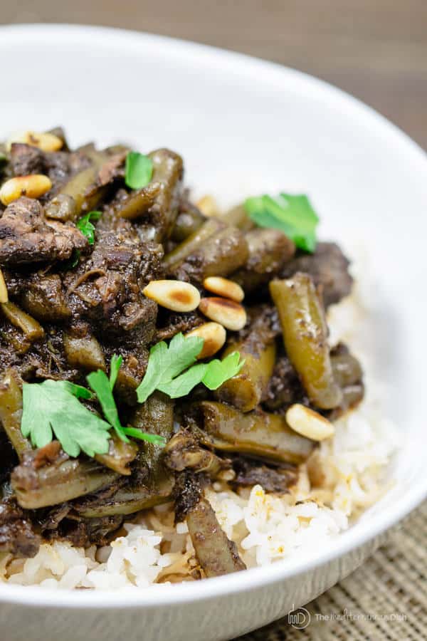 Mediterranean Beef Stew garnished with pine nuts and parsley