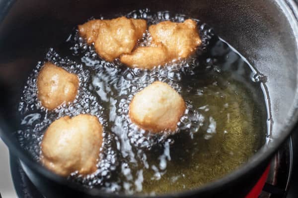 Golden brown donuts while being fried