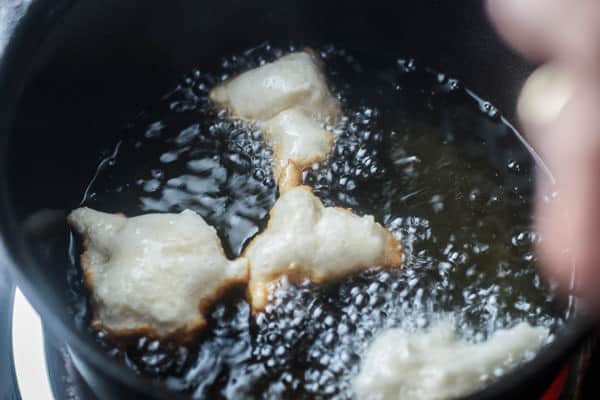 Few donuts in oil being fried