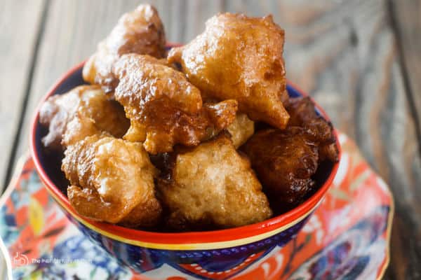 Serving of donuts served in a bowl with cinnamon syrup