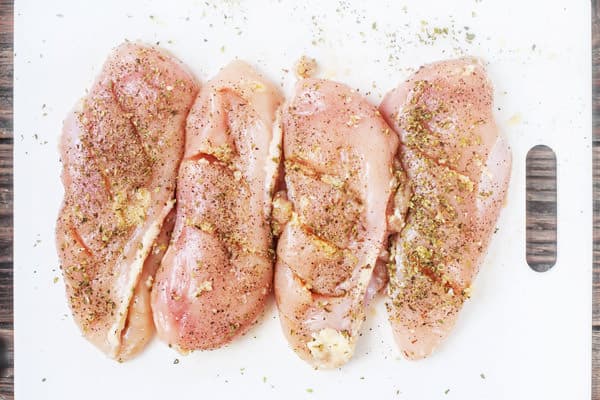 Pat chicken breasts dry. Make three slits on each breast and spread the garlic. Season with salt and pepper on each side.