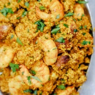 Spicy couscous with shrimp and chorizo served in a bowl