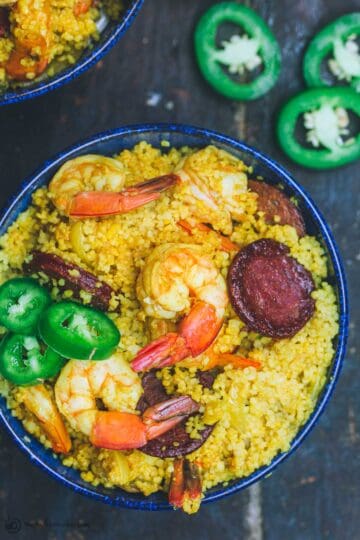 Spicy couscous with shrimp and chorizo served in a bowl
