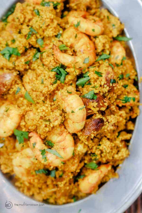 Spicy couscous with shrimp and chorizo served in a bowl