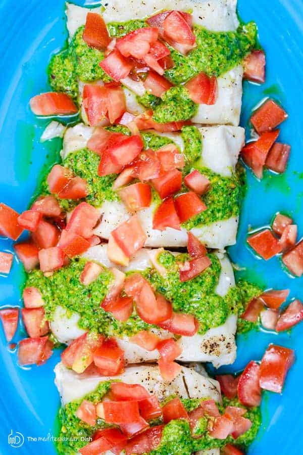 Pistachio Cilantro Pesto and diced tomatoes on top of baked cod