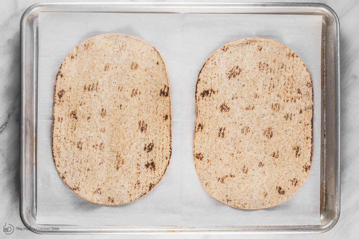 Flatbread on baking sheet lined with parchment paper