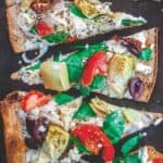 Flatbread pizza with garden vegetables and feta cheese