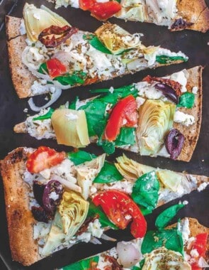 Flatbread pizza with garden vegetables and feta cheese