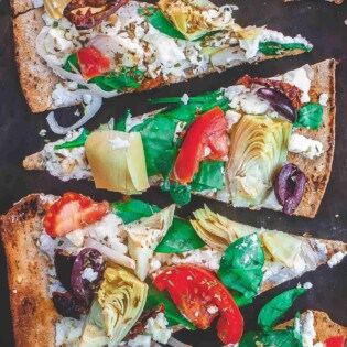 Flatbread pizza with garden vegetables and feta cheese