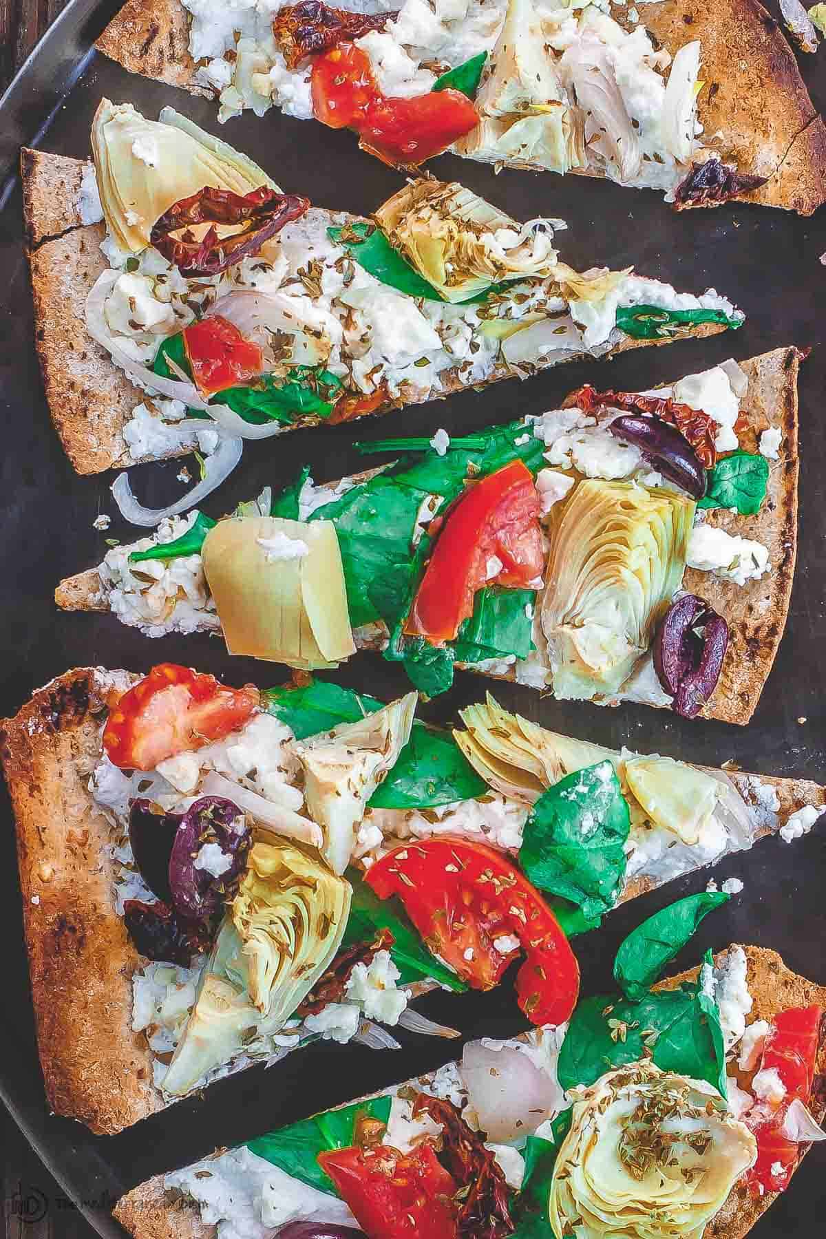 Flatbread pizza with garden vegetables and feta cheese