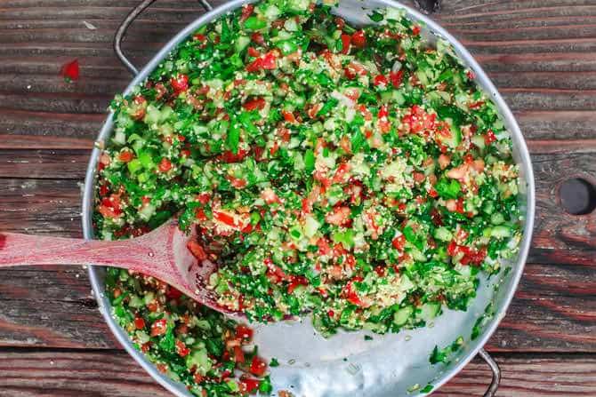 Tomatoes, onion, bulgur, parsley and herbs mixed to make tabouli salad