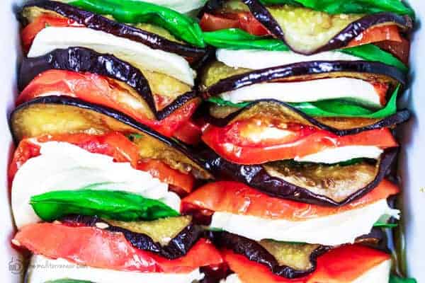 Tomatoes, cheese and Eggplant lined in a row in a dish