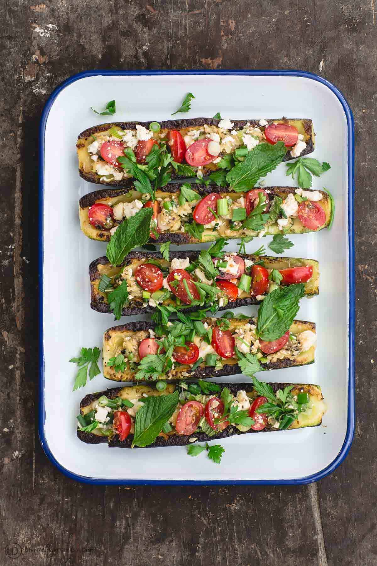 Mediterranean grilled zucchini boats filled with tomato, feta, and fresh herb mixture