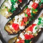 Mediterranean Grilled Zucchini Recipe | The Mediterranean Dish. Quick olive oil grilled zucchini topped with tomato, feta and green onions. Comes together in less than 15 minutes! The perfect appetizer or side dish. See it on TheMediterraneanDish.com